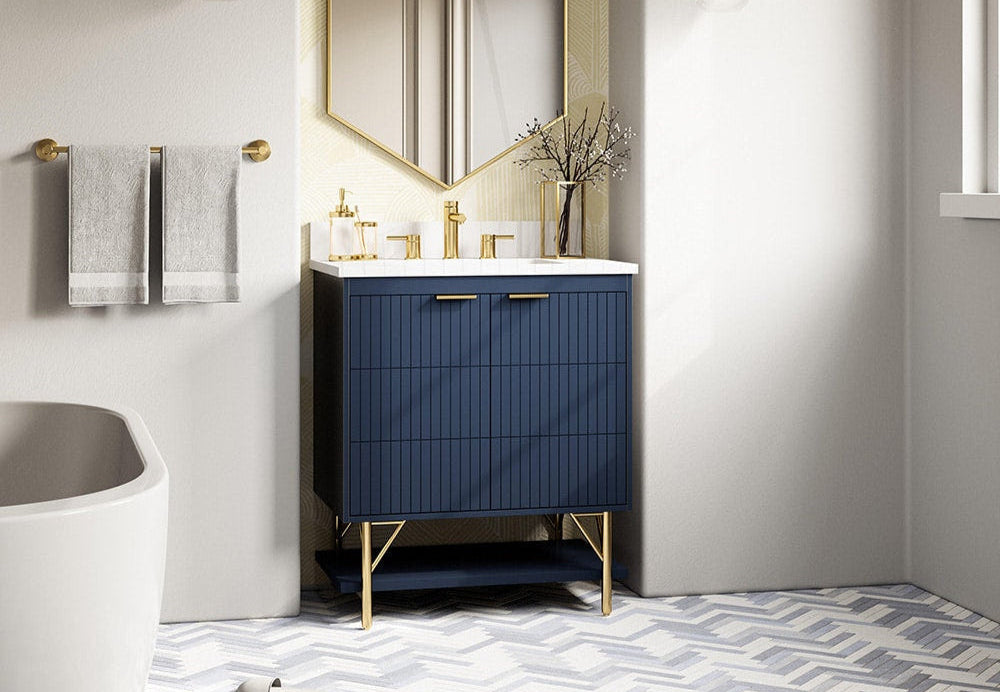 Bathroom with a blue vanity cabinet, white sink, and decorative elements.
