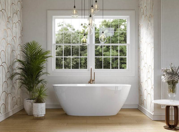Modern bathroom with a freestanding bathtub, window, and decorative elements.