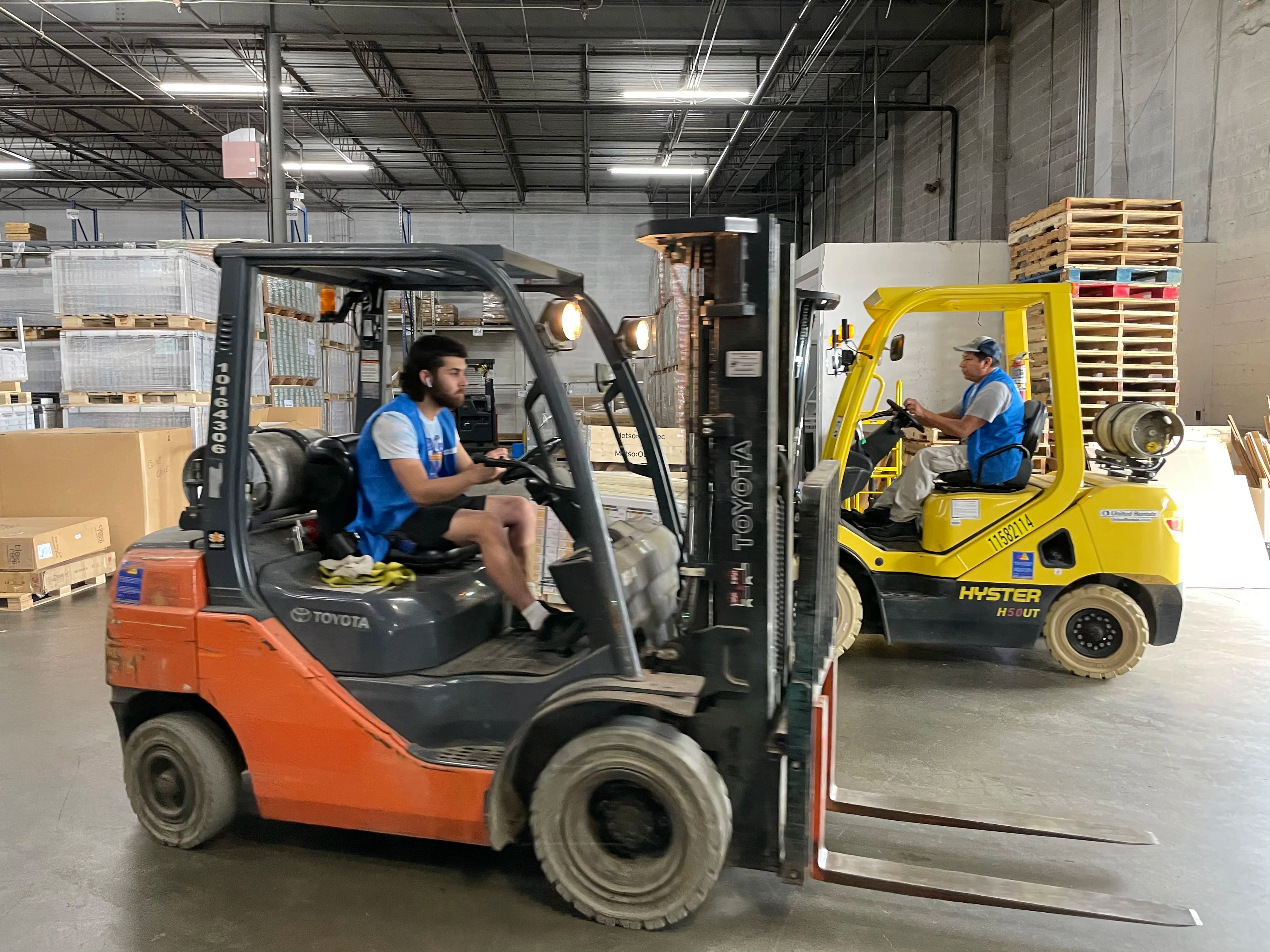 Forklift Operators Unloading Truck