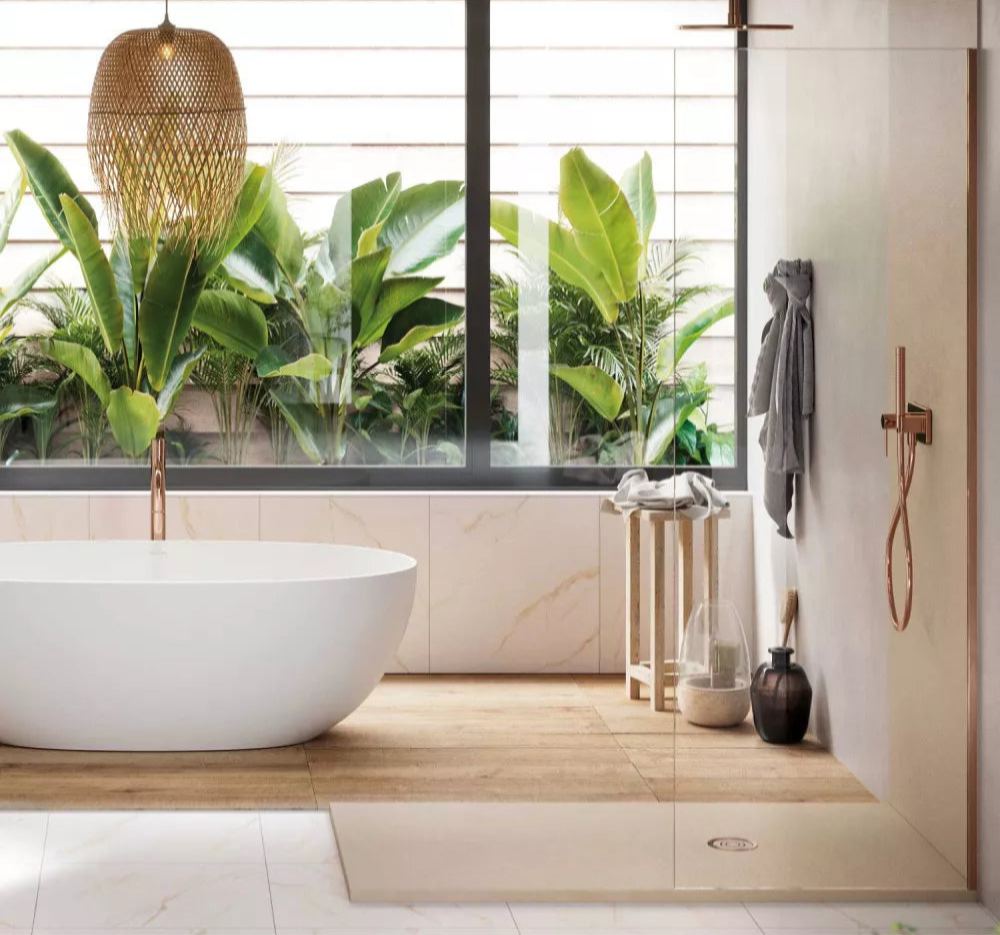 Modern bathroom with a white freestanding bathtub, wooden shelf, and large window with plants outside.