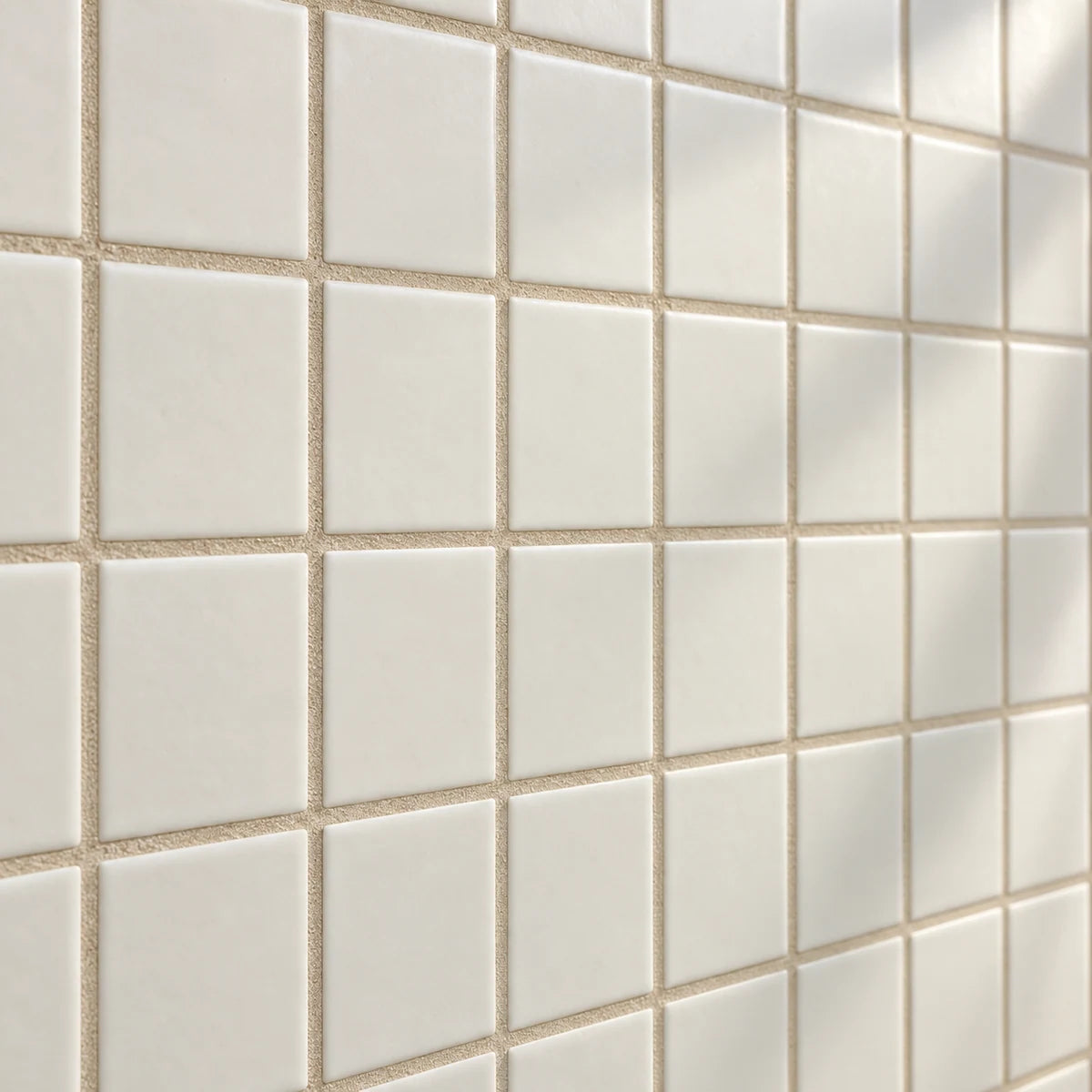 Sand-beige grout between ivory square ceramic tiles